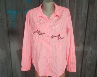May include: A pink long-sleeved button-down shirt with silver and pink embroidery that reads "Limited Edition" and "Spanish Blues".