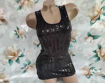 May include: A black sleeveless top with a sequined design. The top has a scoop neckline and a fitted silhouette.