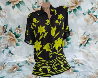 90s Vintage women's black transparent short sleeve long blouse with bright green floral print. Size L.