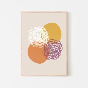 May include: Abstract art print with three overlapping circles in shades of orange, yellow, and purple. The circles are filled with white, purple, and yellow scribbles.