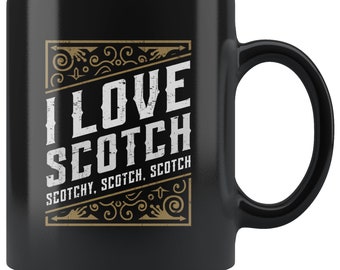 May include: Black ceramic coffee mug with a white design that says "I Love Scotch" with the words "Scotchy, Scotch, Scotch" underneath. The design is surrounded by a gold frame with decorative swirls.