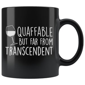 May include: Black ceramic coffee mug with a white graphic of a wine glass and the text "Quaffable but far from transcendent".