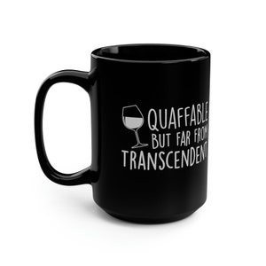 May include: Black ceramic coffee mug with a white wine glass graphic and the text "Quaffable but far from transcendent".