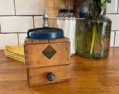 Vintage French coffee grinder with blue lid and handle
