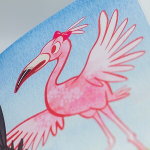 May include: A pink flamingo with a pink bow on its head is flying with its wings spread out. The background is a light blue sky.