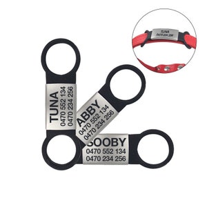 May include: Three silver dog tags with black rings. The tags are engraved with the names "Tuna", "Abby", and "Scooby" along with phone numbers.