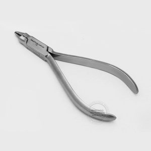 May include: A silver orthodontic pliers with a curved handle and a small, pointed tip. The pliers are labelled "Meditools.com.au CE".