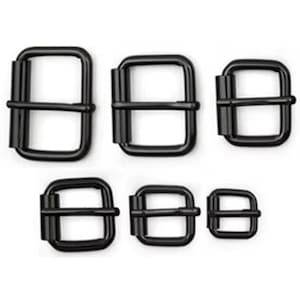May include: A collection of six black metal rectangular belt buckles in varying sizes. The buckles are arranged on a white background, showcasing their simple, yet functional design. Ideal for leathercraft projects or adding a modern touch to accessories.