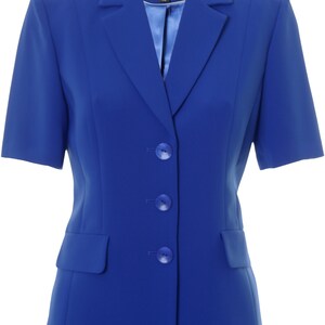 May include: A royal blue blazer with short sleeves and three buttons. The blazer has a pocket on the left side and a label that says "Busy" with the size "10" printed on it.