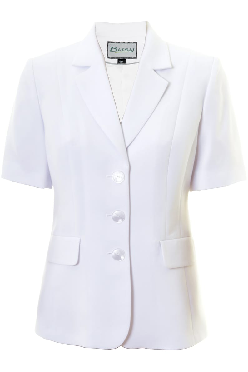 May include: A white short-sleeved blazer with a single button closure and two pockets. The blazer has a label that says "Busy" on it.