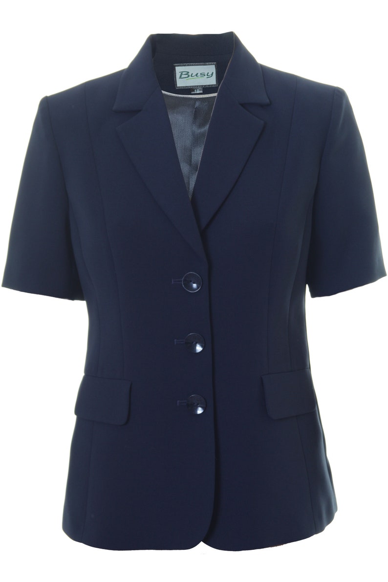 May include: A navy blue blazer with short sleeves and three buttons. The blazer has a single pocket on the left side and the label "Busy" on the collar.
