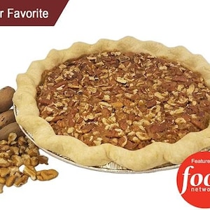 May include: A pecan pie with a golden brown crust and a generous amount of pecans on top. The pie is a customer favorite and has been featured on the Food Network.