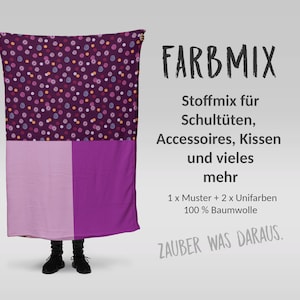 Könnte beinhalten: Ein lila und pinkfarbener Stoff mit einem bunten Punkte-Muster. Der Stoff ist mit "FARBMIX Stoffmix für Schultüten, Accessoires, Kissen und vieles mehr 1 x Muster + 2 x Unifarben 100% Baumwolle ZAUBER WAS DARAUS." beschriftet.