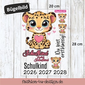 Könnte beinhalten: Ein rechteckiger Aufbügler mit einem Cartoon-Leoparden-Design, einem rosa Herz und dem Text "Schulkind" und "2026 2027 2028". Der Aufbügler ist 20 cm breit und 28 cm hoch.
