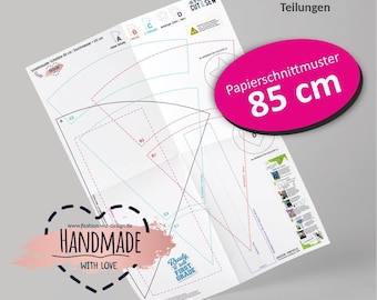 May include: A white paper sewing pattern for an 85 cm school cone, featuring black and coloured dashed lines, technical diagrams, and text including SCHNITTMUSTER, Papierschnittmuster 85 cm, and HANDMADE WITH LOVE, with various section labels.