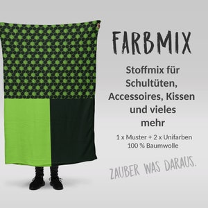 Könnte beinhalten: Ein Textil mit einem geometrischen Muster in Grün und Schwarz sowie einem einfarbigen grünen und schwarzen Abschnitt. Der Text "FARBMIX" steht oben, mit zusätzlichem Text darunter. Das Textil besteht aus 100 % Baumwolle.