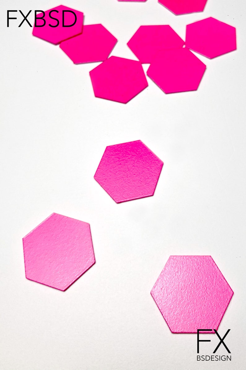 May include: A collection of pink hexagonal paper shapes scattered on a white surface. The text "FX BSDESIGN" is visible in the bottom right corner of the image.