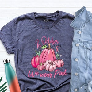 En octubre usamos una camiseta de calabaza rosa, una camiseta contra el cáncer de mama, una camiseta de calabaza para la concientización sobre el cáncer de mama, una camiseta de calabaza guerrera de otoño para Halloween.