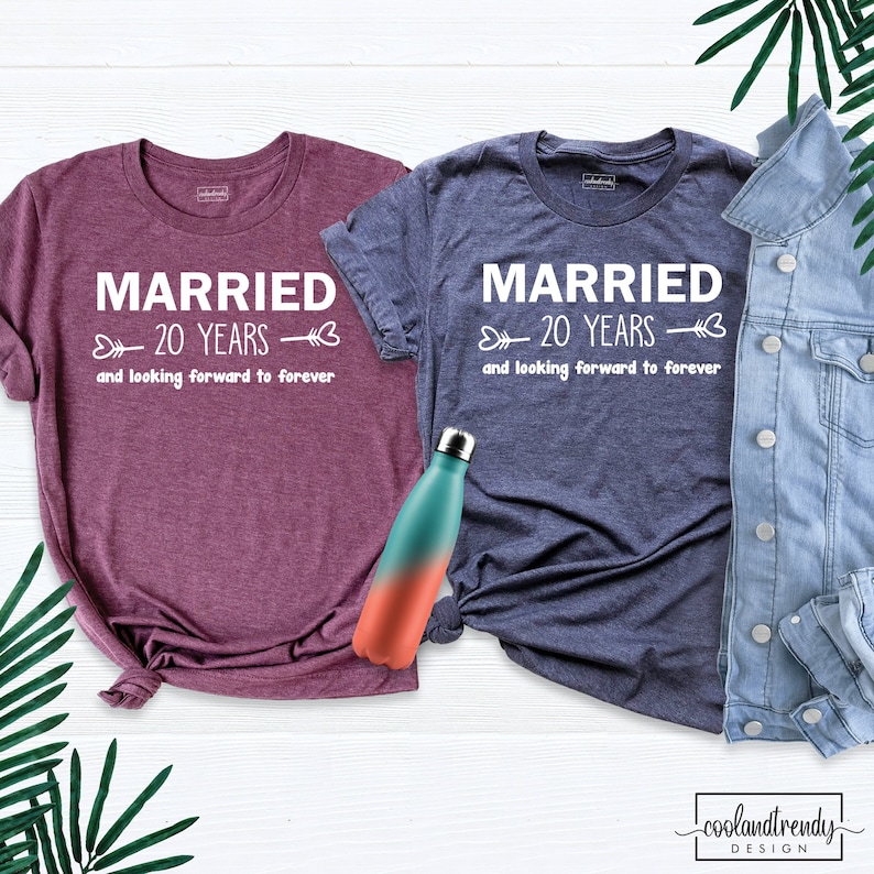 May include: Two t-shirts with the text "Married 20 Years and looking forward to forever" in white text on a maroon and a navy blue shirt.