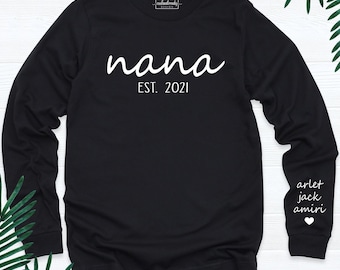 May include: A black long-sleeve shirt featuring the white text "nana EST. 2021" on the chest. The right sleeve displays the white text "arlet jack amiri" above a small white heart icon. A small "coolandtrendy DESIGN" logo is at the neck.