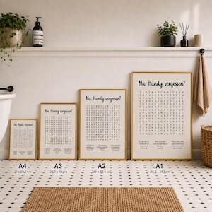 May include: Four framed posters in A4, A3, A2, and A1 sizes, each featuring a word search puzzle with the German text 'Na, Handy vergessen?' at the top. The posters are displayed in a row on a floor with a black and white diamond pattern.