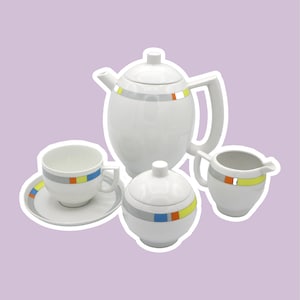 May include: A white porcelain tea set with a geometric design in shades of gray, yellow, orange, and blue. The set includes a teapot, creamer, sugar bowl, and a cup and saucer.