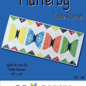 May include: A quilt pattern for a table runner called "Flutterby" with a design of colorful butterflies. The pattern is 18 inches by 36 inches and is a quilt-as-you-go project. The pattern is from GE Designs Iceland.
