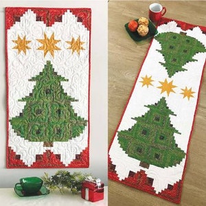 May include: A white quilted table runner with a red border features a green Christmas tree design with gold stars. The runner is approximately 17 inches wide and 54 inches long.