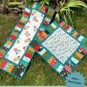 May include: A green, red, and white table runner with a floral pattern. The table runner is made from fabric scraps and is called "Bentley Table Runner". The text "Uses a Charm Pack!" is in a yellow starburst shape in the bottom right corner of the image.