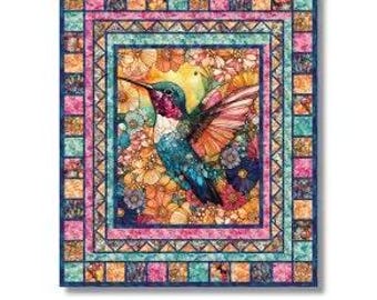 May include: A colorful quilt pattern titled "Humming Beauty" featuring a hummingbird with vibrant blue, red, and orange feathers. The quilt measures 61.5 x 71.5 inches. The design is by Matthew Pridemore and is for advanced beginners.