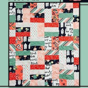 May include: A quilt pattern called "Busy Bee" with a patchwork design featuring various colors and patterns, including red, pink, green, and black. The quilt is made up of squares and rectangles with different words and phrases written on them. The quilt is surrounded by a border with a floral design.