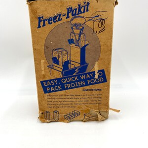 May include: A brown cardboard box with a blue and white illustration of a freezer pack kit. The box has the text "Freez-Pakit" and "Easy, Quick Way to Pack Frozen Food" printed on it. The instructions for using the kit are printed on the bottom of the box.