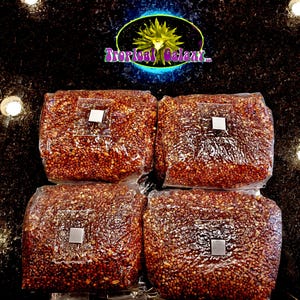 May include: Four clear plastic bags filled with brown and white grains. Each bag has a small white square label.