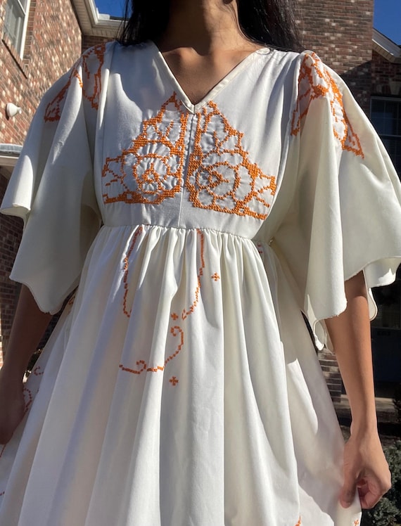 white dress with orange embroidery Orange Creek Embroidered Dress Floral Accents
