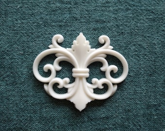 May include: White decorative trim with a scroll design. The trim is made of a lightweight material and has a smooth finish.