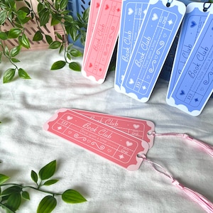 May include: Four pink and blue bookmark designs with a ticket shape and the text "Book Club" and "Once upon a time".