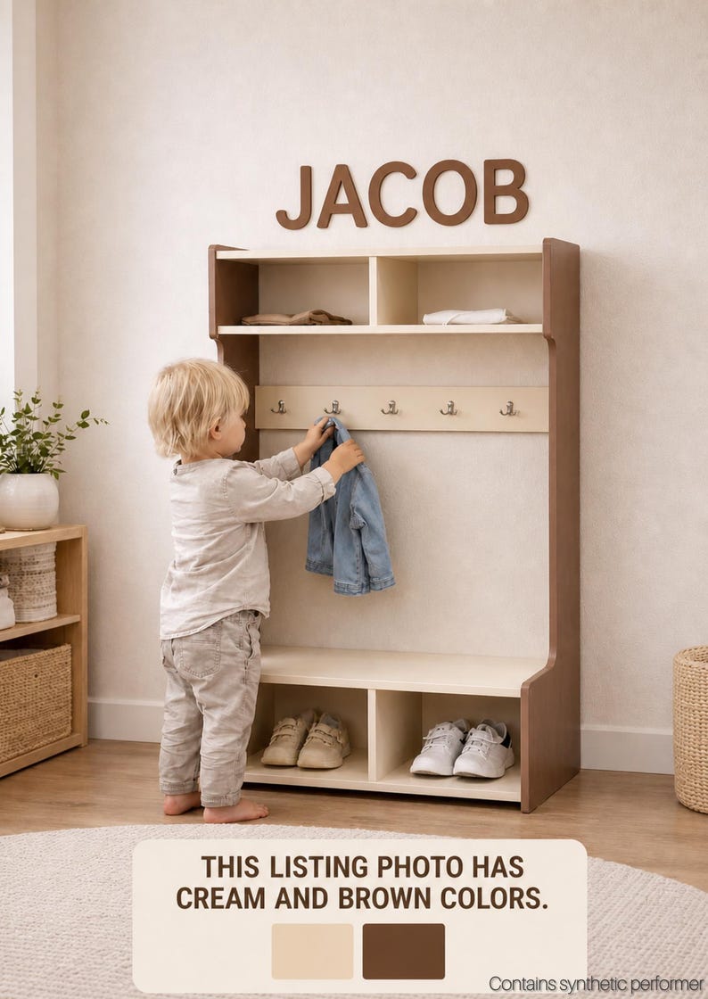 May include: A cream and brown wooden entryway storage unit featuring a top shelf, a middle section with five metal hooks, and a bottom bench with two open cubbies. The word JACOB is mounted on the wall above the unit. The text THIS LISTING PHOTO HAS CREAM AND BROWN COLORS is printed at the bottom.