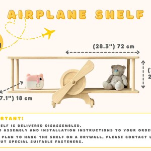 May include: A wooden airplane shelf with a pink toy and a teddy bear on it. The shelf is 28.3 inches wide and 7.9 inches tall. The shelf is delivered unassembled and includes assembly and installation instructions.