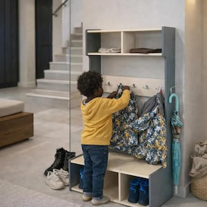 May include: A gray and light wood entryway storage unit featuring an upper shelf, a central row of metal hooks for hanging items, and a lower bench with two open storage compartments. A light blue umbrella hangs from a side hook on the unit.