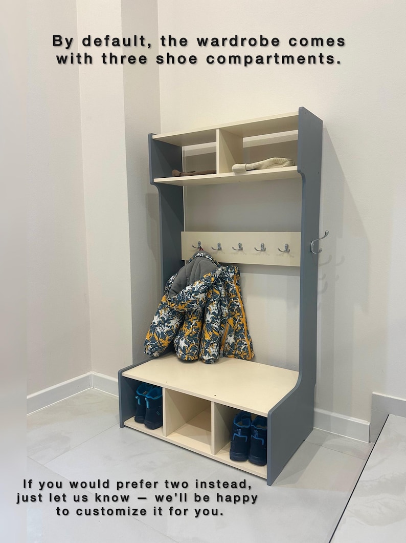 May include: A gray and cream hall tree featuring an upper shelf, a central panel with five silver hooks, and a lower bench with three shoe compartments. Text reads: By default, the wardrobe comes with three shoe compartments. If you would prefer two instead, just let us know - we'll be happy to customize it for you.