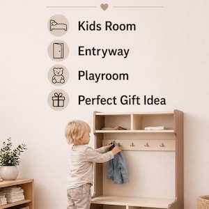 May include: A light-colored wooden storage unit featuring an upper shelf with two compartments, a middle section with four metal hooks, and a lower bench with two open storage cubbies. The wall above displays text reading Perfect for Kids Room, Entryway, Playroom, Perfect Gift Idea.