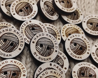 May include: A close-up of several wooden buttons with the text "HAND KNITTED BY SUSAN" engraved on them. The buttons are round and have a natural wood color.