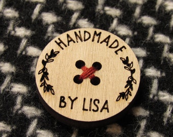 May include: A round wooden button with the text "HANDMADE BY LISA" and a red thread sewn in an X pattern in the center.