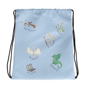 May include: Light blue drawstring bag featuring illustrations of St. Francis, St. Patrick, St. Joseph, St. Michael, St. Carlo, and St. George. Each saint is represented by a unique symbol, such as a bird, a dragon, and a laptop.