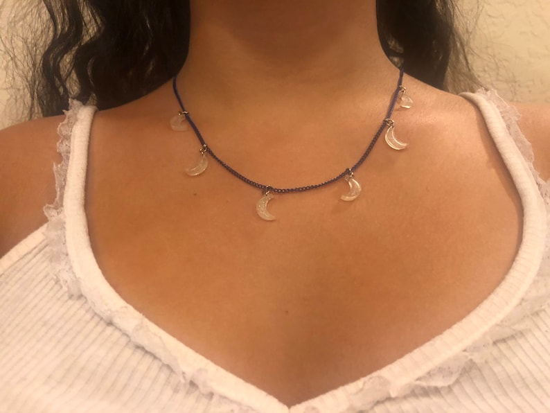 light pink glitter moons on a navy blue chain