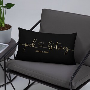 May include: Black lumbar pillow with gold lettering that reads "jack ♥ britney APRIL 3, 2020".