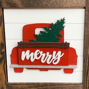 May include: Red wooden truck with a green tree in the back and the word "merry" in white letters on the side.