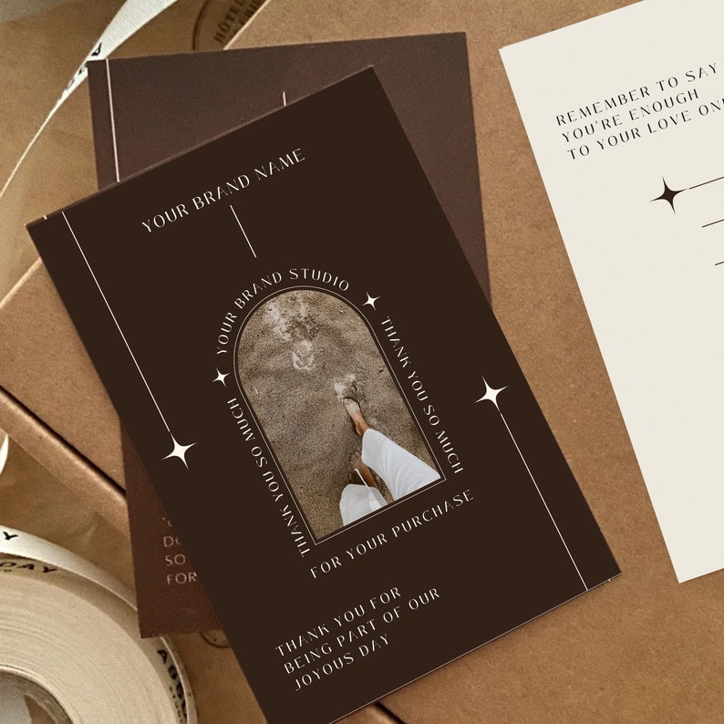 May include: A brown thank you card with a white archway design. The archway contains a photo of a person's feet walking on a sandy beach. The text on the card reads "Your Brand Studio", "Thank you so much for your purchase", and "Thank you for being part of our joyous day".