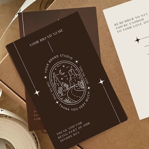 May include: A brown card with white text and a graphic of a desert landscape with a crescent moon and stars. The text reads "Your Brand Studio" and "Thank you for being part of our joyous day".