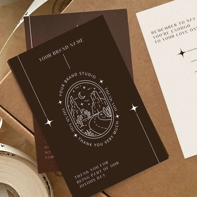 May include: A brown card with white text and a graphic of a desert landscape with a crescent moon and stars. The text reads "Your Brand Studio" and "Thank you for being part of our joyous day".
